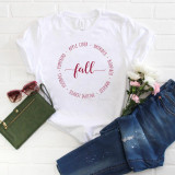 Fall Text circle Sublimation Transfer, a white T-shirt with a fall-themed circular text design and the word 'fall' in the center, surrounded by words like pumpkin, apple cider, hayrides, bonfires, harvest, football, and fall.