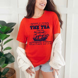 Spilling The Tea Since 1773 DTF Heat Transfer, a woman wearing a red T-shirt with nautical ship graphic and text design.
