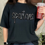 Spartans Sequin Patch, glittery black sequin patch spelling 'spartans' on a black T-shirt.