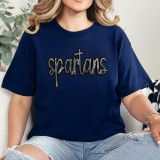 Spartans Sequin Patch, close-up of a navy blue t-shirt featuring a black sequin embroidered logo of 'Spartans' in cursive font.