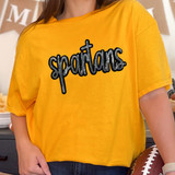 Spartans Sequin Patch, a sparkling black and silver embroidered patch spelling 'spartans' on a yellow t-shirt.