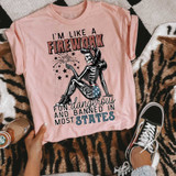 I'm Like A Firework DTF Heat Transfer, pink t-shirt with a skeleton girl holding a firework, with text about being fun, dangerous, and bold in the USA