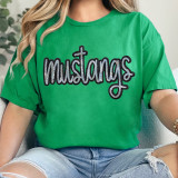 Mustangs Sequin Patch, green t-shirt with the word 'mustangs' written in black and silver sequins, featuring a cross integrated into the design.