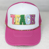 Colorful Crescent Hat Chain, pink and white baseball cap with colorful embroidered 'TEACH' text and decorative chain embellishment.