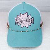 Natural Pink Stone Hat Chain, a delicate gold chain with small pink stones draped around a turquoise and pink trucker hat with scenic embroidery.