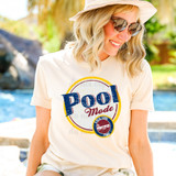 Pool Mode DTF Heat Transfer, colorful woman wearing casual summer outfit with the printed design on t-shirt, outdoor sunny poolside scene.