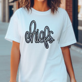Chiefs Sequin Patch, close-up of a white T-shirt with a sequined 'Chiefs' patch in black and silver on the front.