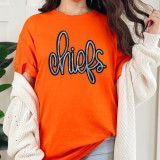 Chiefs Sequin Patch, close-up of a woman wearing an orange T-shirt with a black and silver sequined Chiefs logo patch.