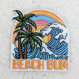 Beach Bum Embroidered HAT/POCKET Patch, colorful patch featuring palm trees, ocean waves, a vibrant sunset, and the words 'BEACH BUM' in orange embroidered text.