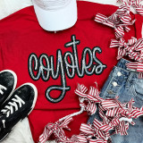 Coyotes Sequin Patch, a red T-shirt with a colorful sequin design of the brand name 'Coyotes' displayed flat among stylish sneakers, striped ribbon ties, and denim jeans in a flat lay fashion arrangement.