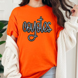 Coyotes Sequin Patch, close-up of a woman wearing an orange t-shirt with a black and multicolored sequin embroidered 'Coyotes' patch