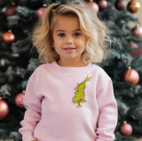 Little Tree Hat/Pocket Screen Print Heat Transfer, Christmas tree design on a pink sweatshirt worn by a young girl in front of a decorated Christmas tree.