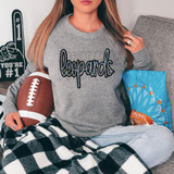 Leopards Faux Sequin Patch DTF Heat Transfer, close-up of a woman wearing a grey sweatshirt with a black and blue sequined leopard print patch on the chest.