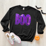 Purple BOO Sequin Patch, sequined purple and pink patch with the word 'BOO' on a black sweatshirt.