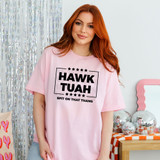 Hawk Tuah BLACK DTF Heat Transfer, a black text design on a pink T-shirt worn by a woman with red hair.