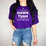 Hawk Tuah WHITE DTF Heat Transfer, a white heat transfer design printed on a purple t-shirt with the text 'HAWK TUAH' and 'SPIT ON THAT THANG'.