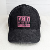 Easily Distracted By Everything FAUX Leather Patch, black baseball cap with pink and black embroidered patch displaying the text 'Easily Distracted By Everything'.