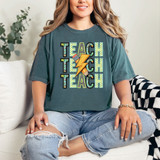 Teach Stacked Blue/Green DTF Heat Transfer, colorful and vibrant multicolor heat transfer design on a casual t-shirt worn by a smiling woman.