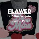 FLAWED Be Mine Sequin Chenille Patch, decorative heart-shaped sequin patch with pink and white design on a black fabric background.