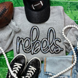 Rebels Sequin Patch, sparkling black and silver embroidered patch on grey sweatshirt with athletic shoes, baseball cap, white beads, and denim jeans.