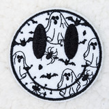 Spooky Smile Embroidered HAT/POCKET Patch, round Halloween-themed embroidery featuring a spooky smiling face with bats and spiders.