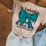In September, We Wear Teal Ovarian Cancer Awareness DTF Heat Transfer, teal bow with hearts design for ovarian cancer awareness on a t-shirt.