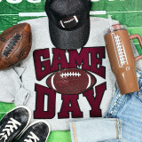 Maroon Chenille Game Day with Sequin Football Patch, a cozy unisex sweatshirt featuring bold red and black lettering and a sparkling sequin football patch design, ideal for sports-themed casual wear.