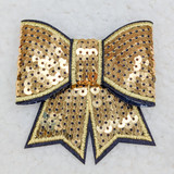 Gold Sequin Bow HAT/POCKET Patch, decorative gold sequined bow with black and yellow embroidered edges and a small gold and black sequined patch in the center.