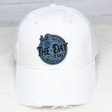 Have The Day You Deserve FAUX Leather Patch, white baseball cap with a blue and black embroidered patch featuring a skeleton bear and the motivational message.