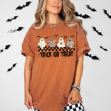 Trick Or Treat Ghosts DTF Heat Transfer, Halloween T-shirt featuring ghost characters with leopard patterns and the text "Trick Or Treat" on an orange shirt.