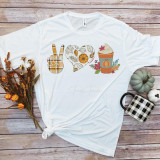 Peace Love and Pumpkin Spice Sublimation Transfer T-shirt with fall-themed design, including a peace sign, a heart with autumn leaves, and a pumpkin spice latte, laid on a wooden surface with flowers, pumpkins, and a mug around it.