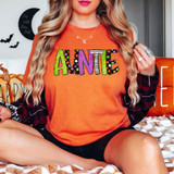Auntie Halloween Letters DTF Heat Transfer, colorful Halloween-themed letters spelling 'AUNTIE' on an orange T-shirt.