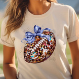 Bow Football Coquette DTF Heat Transfer, a colorful mosaic-style football design with a blue bow on a white t-shirt.