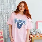 Mama Blue Floral Chinoiserie DTF Heat Transfer, product image featuring a woman wearing a pink T-shirt with a blue floral bow design and the word 'Mama' across the front.