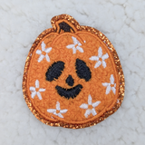 Daisy Jack O Lantern Embroidered Chenille HAT/POCKET Patch, Halloween themed orange pumpkin design with a smiling face and white flowers embellishments