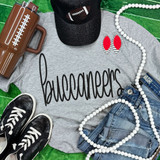Buccaneers Black PUFF Screen Print Heat Transfer, black puffed text on a gray T-shirt with sports-themed accessories.