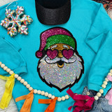 Sequin Santa with Heart Eyes Patch, colorful glittery embroidered Christmas patch on a blue sweatshirt.