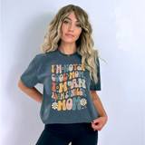 Product: I'm Not A Cool Mom I'm An Adam Sandler Mom Retro DTF Heat Transfer, a woman wearing a t-shirt with a colorful, retro-style print and daisy illustrations.