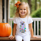 Spooky Cutie DTF Heat Transfer, colorful and cute Halloween-themed graphic featuring a rainbow ghost with bows and flowers on a white girl T-shirt.