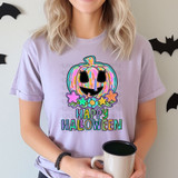 Happy Halloween Stars DTF Heat Transfer, colorful pumpkin with a smiling face and stars, Halloween-themed design on a lavender T-shirt.