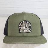 Not All Who Wander Are Lost FAUX Leather Patch, green and black trucker cap with embroidered patch featuring a compass and the phrase 'Not All Who Wander Are Lost'.