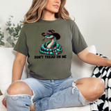 Product Don't Tread On Me Cowboy Snake DTF Heat Transfer, featuring a snake wearing a cowboy hat and the phrase 'Don't Tread On Me' printed on a green t-shirt.