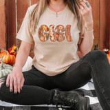 Gigi Fall Pattern DTF Heat Transfer, colorful autumn-themed pattern used for transferring onto textiles on a t-shirt.