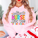 Jolliest Nurse This Side Of The School DTF Heat Transfer, colorful and playful text on a pink sweatshirt worn by a woman with long blonde hair.