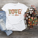 Love Thanksgiving Sublimation Transfer, white T-shirt with Thanksgiving-themed design, including the word LOVE and decorative elements, displayed on a rustic wooden surface with jeans, plaid blanket, and cotton flowers.