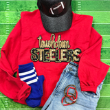 Touchdown Steelers Sequin Patch, decorative patch with shiny gold and black sequins spelling out 'touchdown STEELERS' on red sweatshirt, paired with a black football cap and accessories on a green football field background.