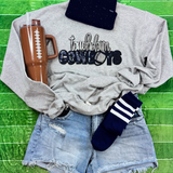 Touchdown Cowboys Sequin Patch, an embroidered patch with the words 'touchdown' and 'COWBOYS' decorated with sequins, placed on a gray sweatshirt.