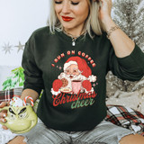 I Run On Coffee And Christmas Cheer DTF Heat Transfer, Christmas-themed shirt featuring Santa Claus holding a coffee mug and cookie, with festive holiday background.