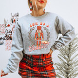 Son Of A Nutcracker Vintage DTF Heat Transfer, festive holiday sweatshirt featuring a nutcracker graphic and Christmas decorations.