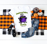 Sanderson Sisters Brewery Sublimation Transfer, Halloween themed white T-shirt with witch's brew cauldron graphic and festival-style lettering, displayed with pumpkins, shoes, and plaid fabric.